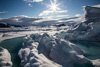 frozen ocean and icebergs and sunshine and mountains of bylot island - 